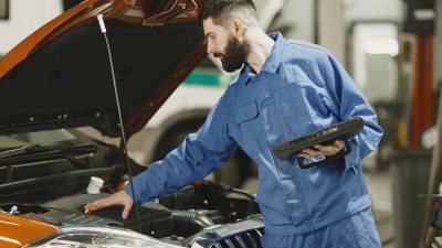 Mechanic using GST ready auto repair software in an Indian garage 2026